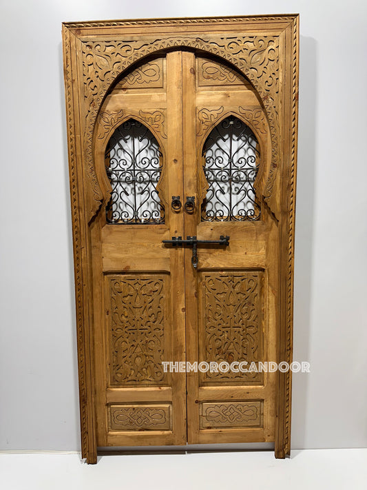 Hand-carved Moroccan door in solid cedar with intricate geometric patterns. (Highlights material, design, and details)