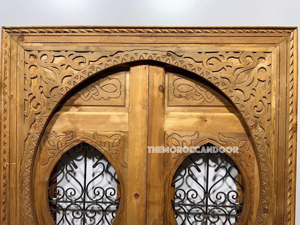Hand-carved Moroccan door as a unique and stylish headboard, adding a touch of Moroccan flair to the bedroom. (Focuses on alternative use as a headboard and highlights Moroccan style)