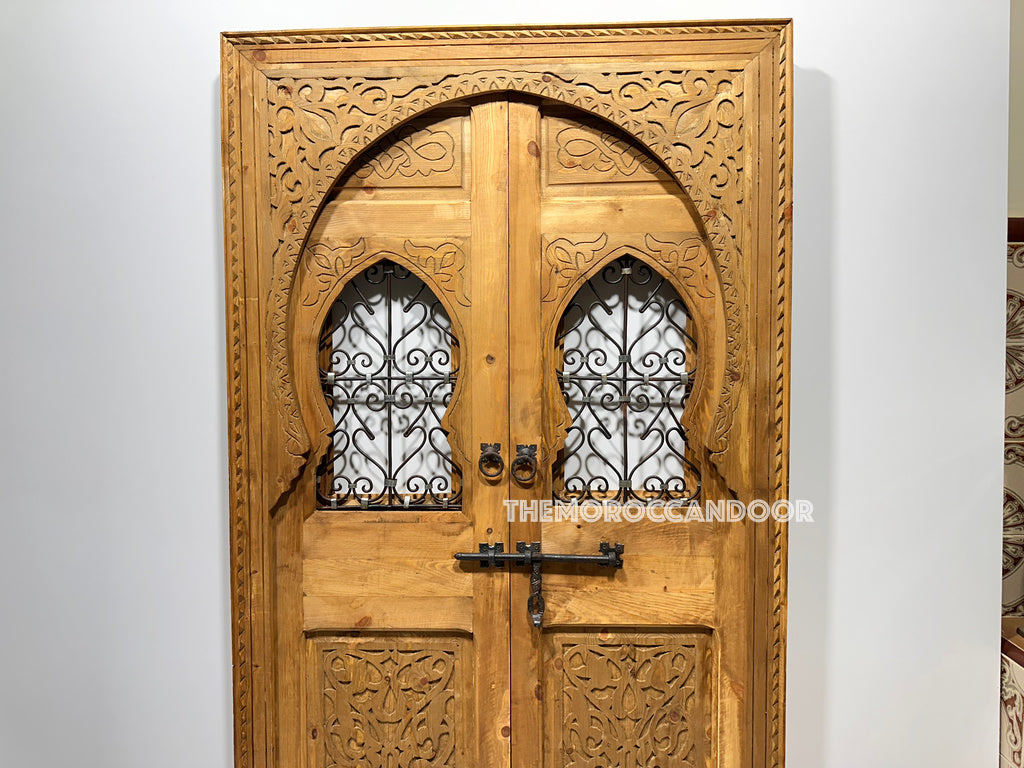Hand-carved Moroccan door framing a cozy fireplace, creating a warm and inviting ambiance. (Highlights functionality for fireplaces and emphasizes warmth and ambiance)