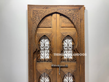 Detail shot of the door's intricate carvings with a close-up of the artisan's hand working on the design.
