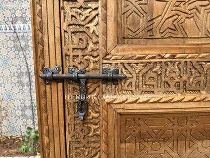  Where Strength Meets Beauty: Hand-carved double wooden doors, a harmonious blend of robust construction, intricate carvings, and unwavering security for your home. (
