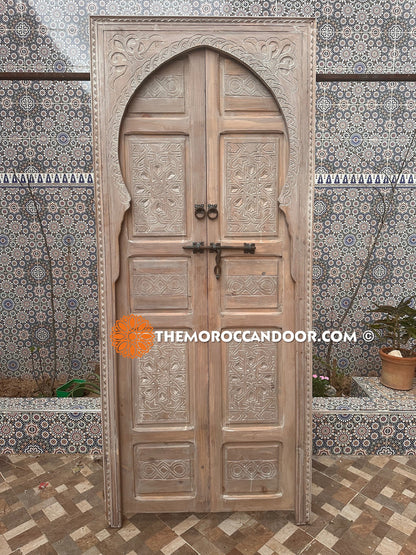 Elegance and Moroccan craftsmanship combine in this custom hand-carved door with white Color, bringing the magic of Morocco into your home.